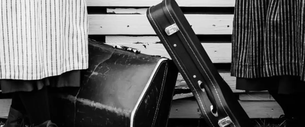 Satteli sisters in traditional Swiss dress, smiling at each other