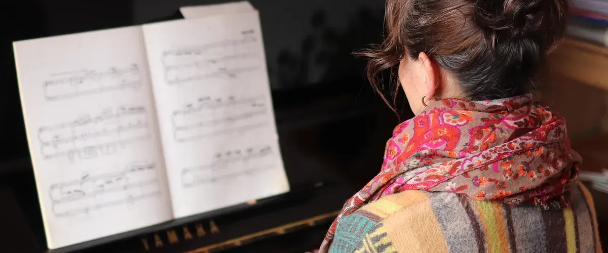 Helen playing piano with sheet music