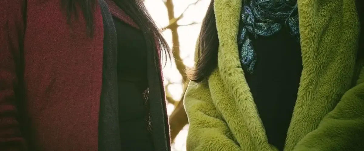 Calluna Sun stand in a woodland and smile at the camera